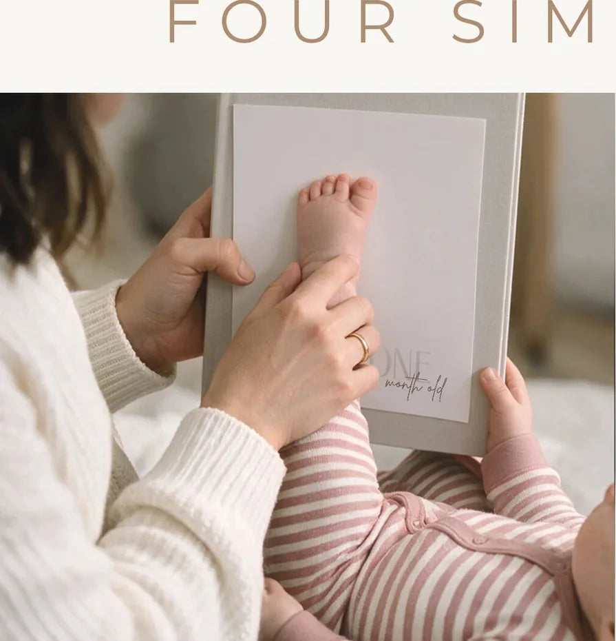 A baby foot being pressed onto a keepsake milestone card